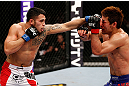 SAITAMA, JAPAN - MARCH 03:  (L-R) Brad Tavares punches Riki Fukuda in their middleweight fight during the UFC on FUEL TV event at Saitama Super Arena on March 3, 2013 in Saitama, Japan.  (Photo by Josh Hedges/Zuffa LLC/Zuffa LLC via Getty Images)