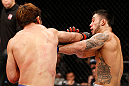 SAITAMA, JAPAN - MARCH 03:  (L-R) Riki Fukuda punches Brad Tavares in their middleweight fight during the UFC on FUEL TV event at Saitama Super Arena on March 3, 2013 in Saitama, Japan.  (Photo by Josh Hedges/Zuffa LLC/Zuffa LLC via Getty Images)