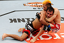 SAITAMA, JAPAN - MARCH 03:  (L-R) Rani Yahya takes down Mizuto Hirota in their featherweight fight during the UFC on FUEL TV event at Saitama Super Arena on March 3, 2013 in Saitama, Japan.  (Photo by Josh Hedges/Zuffa LLC/Zuffa LLC via Getty Images)