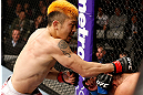 SAITAMA, JAPAN - MARCH 03:  (L-R) Mizuto Hirota punches Rani Yahya in their featherweight fight during the UFC on FUEL TV event at Saitama Super Arena on March 3, 2013 in Saitama, Japan.  (Photo by Josh Hedges/Zuffa LLC/Zuffa LLC via Getty Images)