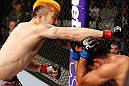 SAITAMA, JAPAN - MARCH 03:  (L-R) Mizuto Hirota punches Rani Yahya in their featherweight fight during the UFC on FUEL TV event at Saitama Super Arena on March 3, 2013 in Saitama, Japan.  (Photo by Josh Hedges/Zuffa LLC/Zuffa LLC via Getty Images)