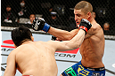 SAITAMA, JAPAN - MARCH 03:  (R-L) Diego Sanchez and Takanori Gomi trade punches in their lightweight fight during the UFC on FUEL TV event at Saitama Super Arena on March 3, 2013 in Saitama, Japan.  (Photo by Josh Hedges/Zuffa LLC/Zuffa LLC via Getty Images)