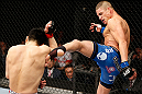 SAITAMA, JAPAN - MARCH 03:  (R-L) Diego Sanchez kicks Takanori Gomi in their lightweight fight during the UFC on FUEL TV event at Saitama Super Arena on March 3, 2013 in Saitama, Japan.  (Photo by Josh Hedges/Zuffa LLC/Zuffa LLC via Getty Images)