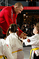 MONTREAL, QC - MARCH 13:  UFC welterweight champion Georges St-Pierre greets students of the Sunfuki Karate school during the UFC 158 open workouts at Complexe Desjardins on March 13, 2013 in Montreal, Quebec, Canada.  (Photo by Josh Hedges/Zuffa LLC/Zuffa LLC via Getty Images)