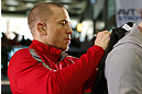 MONTREAL, QC - MARCH 13:  UFC welterweight champion Georges St-Pierre signs autographs for fans in attendance during the UFC 158 open workouts at Complexe Desjardins on March 13, 2013 in Montreal, Quebec, Canada.  (Photo by Josh Hedges/Zuffa LLC/Zuffa LLC via Getty Images)