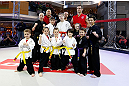 MONTREAL, QC - MARCH 13:  UFC welterweight champion Georges St-Pierre poses for photos with students of the Sunfuki Karate school during the UFC 158 open workouts at Complexe Desjardins on March 13, 2013 in Montreal, Quebec, Canada.  (Photo by Josh Hedges/Zuffa LLC/Zuffa LLC via Getty Images)