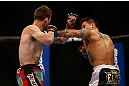 MONTREAL, QC - MARCH 16: Reuben Duran lands a punch against George Roop in their bantamweight bout during the UFC 158 event at Bell Centre on March 16, 2013 in Montreal, Quebec, Canada.  (Photo by Josh Hedges/Zuffa LLC/Zuffa LLC via Getty Images)
