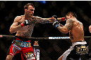 MONTREAL, QC - MARCH 16: George Roop lands a punch against Reuben Duran in their bantamweight bout during the UFC 158 event at Bell Centre on March 16, 2013 in Montreal, Quebec, Canada.  (Photo by Josh Hedges/Zuffa LLC/Zuffa LLC via Getty Images)
