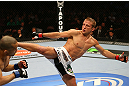 MONTREAL, QC - MARCH 16:  T.J. Dillashaw kicks Issei Tamura in their bantamweight bout during the UFC 158 event at Bell Centre on March 16, 2013 in Montreal, Quebec, Canada.  (Photo by Jonathan Ferrey/Zuffa LLC/Zuffa LLC via Getty Images)