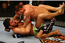 MONTREAL, QC - MARCH 16: (Bottom-Top) Patrick Cote and Bobby Voelkerger grapple in their welterweight bout during the UFC 158 event at Bell Centre on March 16, 2013 in Montreal, Quebec, Canada.  (Photo by Jonathan Ferrey/Zuffa LLC/Zuffa LLC via Getty Images)