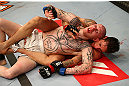 MONTREAL, QC - MARCH 16:  (Bottom-Top) Mike Ricci and Colin Fletcher grapple in their lightweight bout during the UFC 158 event at Bell Centre on March 16, 2013 in Montreal, Quebec, Canada.  (Photo by Josh Hedges/Zuffa LLC/Zuffa LLC via Getty Images)