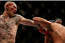 MONTREAL, QC - MARCH 16:  Colin Fletcher lands a punch against Mike Ricci in their lightweight bout during the UFC 158 event at Bell Centre on March 16, 2013 in Montreal, Quebec, Canada.  (Photo by Josh Hedges/Zuffa LLC/Zuffa LLC via Getty Images)