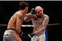 MONTREAL, QC - MARCH 16:  Mike Ricci lands a punch against Colin Fletcher in their lightweight bout during the UFC 158 event at Bell Centre on March 16, 2013 in Montreal, Quebec, Canada.  (Photo by Josh Hedges/Zuffa LLC/Zuffa LLC via Getty Images)