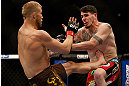 MONTREAL, QC - MARCH 16:  (L-R) Nick Ring kicks Chris Camozzi in their middleweight bout during the UFC 158 event at Bell Centre on March 16, 2013 in Montreal, Quebec, Canada.  (Photo by Josh Hedges/Zuffa LLC/Zuffa LLC via Getty Images)