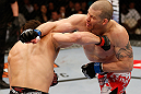MONTREAL, QC - MARCH 16:  (L-R) Jake Ellenberger and \nm trade punches in their welterweight bout during the UFC 158 event at Bell Centre on March 16, 2013 in Montreal, Quebec, Canada.  (Photo by Josh Hedges/Zuffa LLC/Zuffa LLC via Getty Images)