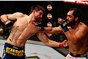 MONTREAL, QC - MARCH 16:  (L-R) Carlos Condit punches Johny Hendricks in their welterweight bout during the UFC 158 event at Bell Centre on March 16, 2013 in Montreal, Quebec, Canada.  (Photo by Josh Hedges/Zuffa LLC/Zuffa LLC via Getty Images)