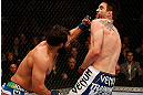 MONTREAL, QC - MARCH 16:  (L-R) Johny Hendricks punches Carlos Condit in their welterweight bout during the UFC 158 event at Bell Centre on March 16, 2013 in Montreal, Quebec, Canada.  (Photo by Josh Hedges/Zuffa LLC/Zuffa LLC via Getty Images)