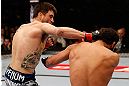 MONTREAL, QC - MARCH 16:  (L-R) Carlos Condit punches Johny Hendricks in their welterweight bout during the UFC 158 event at Bell Centre on March 16, 2013 in Montreal, Quebec, Canada.  (Photo by Josh Hedges/Zuffa LLC/Zuffa LLC via Getty Images)