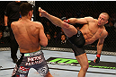 MONTREAL, QC - MARCH 16:  (R-L) Georges St-Pierre throws a kick against Nick Diaz in their welterweight championship bout during the UFC 158 event at Bell Centre on March 16, 2013 in Montreal, Quebec, Canada.  (Photo by Jonathan Ferrey/Zuffa LLC/Zuffa LLC via Getty Images)