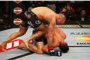 MONTREAL, QC - MARCH 16:  Georges St-Pierre throws a knee to the body of Nick Diaz in their welterweight championship bout during the UFC 158 event at Bell Centre on March 16, 2013 in Montreal, Quebec, Canada.  (Photo by Jonathan Ferrey/Zuffa LLC/Zuffa LLC via Getty Images)