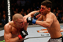 MONTREAL, QC - MARCH 16:  (L-R) Georges St-Pierre punches Nick Diaz in their welterweight championship bout during the UFC 158 event at Bell Centre on March 16, 2013 in Montreal, Quebec, Canada.  (Photo by Josh Hedges/Zuffa LLC/Zuffa LLC via Getty Images)