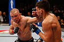 MONTREAL, QC - MARCH 16:  (L-R) Georges St-Pierre punches Nick Diaz in their welterweight championship bout during the UFC 158 event at Bell Centre on March 16, 2013 in Montreal, Quebec, Canada.  (Photo by Josh Hedges/Zuffa LLC/Zuffa LLC via Getty Images)