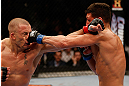 MONTREAL, QC - MARCH 16:  (R-L) Nick Diaz punches Georges St-Pierre in their welterweight championship bout during the UFC 158 event at Bell Centre on March 16, 2013 in Montreal, Quebec, Canada.  (Photo by Josh Hedges/Zuffa LLC/Zuffa LLC via Getty Images)