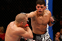 MONTREAL, QC - MARCH 16:  (R-L) Nick Diaz punches Georges St-Pierre in their welterweight championship bout during the UFC 158 event at Bell Centre on March 16, 2013 in Montreal, Quebec, Canada.  (Photo by Josh Hedges/Zuffa LLC/Zuffa LLC via Getty Images)