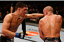 MONTREAL, QC - MARCH 16:  (L-R) Nick Diaz punches Georges St-Pierre in their welterweight championship bout during the UFC 158 event at Bell Centre on March 16, 2013 in Montreal, Quebec, Canada.  (Photo by Josh Hedges/Zuffa LLC/Zuffa LLC via Getty Images)