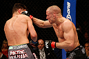 MONTREAL, QC - MARCH 16:  (R-L) Georges St-Pierre punches Nick Diaz in their welterweight championship bout during the UFC 158 event at Bell Centre on March 16, 2013 in Montreal, Quebec, Canada.  (Photo by Josh Hedges/Zuffa LLC/Zuffa LLC via Getty Images)