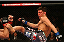 MONTREAL, QC - MARCH 16:  (R-L) Nick Diaz kicks Georges St-Pierre in their welterweight championship bout during the UFC 158 event at Bell Centre on March 16, 2013 in Montreal, Quebec, Canada.  (Photo by Jonathan Ferrey/Zuffa LLC/Zuffa LLC via Getty Images)