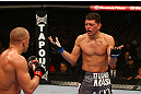 MONTREAL, QC - MARCH 16:  (R-L) Nick Diaz taunts Georges St-Pierre in their welterweight championship bout during the UFC 158 event at Bell Centre on March 16, 2013 in Montreal, Quebec, Canada.  (Photo by Jonathan Ferrey/Zuffa LLC/Zuffa LLC via Getty Images)