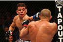 MONTREAL, QC - MARCH 16:  (L-R) Nick Diaz punches Georges St-Pierre in their welterweight championship bout during the UFC 158 event at Bell Centre on March 16, 2013 in Montreal, Quebec, Canada.  (Photo by Jonathan Ferrey/Zuffa LLC/Zuffa LLC via Getty Images)