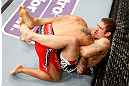 STOCKHOLM, SWEDEN - APRIL 06:  (R-L) Tom Lawlor secures a guillotine choke submission against Michael Kuiper in their middleweight fight at the Ericsson Globe Arena on April 6, 2013 in Stockholm, Sweden.  (Photo by Josh Hedges/Zuffa LLC/Zuffa LLC via Getty Images)