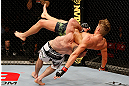 STOCKHOLM, SWEDEN - APRIL 06:  Adlan Amagov (white shorts) takes down Chris Spang in their welterweight fight at the Ericsson Globe Arena on April 6, 2013 in Stockholm, Sweden.  (Photo by Josh Hedges/Zuffa LLC/Zuffa LLC via Getty Images)