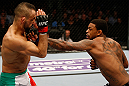 STOCKHOLM, SWEDEN - APRIL 06:  (R-L) Michael Johnson punches Reza Madadi in their lightweight fight at the Ericsson Globe Arena on April 6, 2013 in Stockholm, Sweden.  (Photo by Josh Hedges/Zuffa LLC/Zuffa LLC via Getty Images)