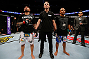 STOCKHOLM, SWEDEN - APRIL 06:  Akira Corassani (L) and Robbie Peralta (R) wait for the judges' decision after their featherweight fight at the Ericsson Globe Arena on April 6, 2013 in Stockholm, Sweden.  (Photo by Josh Hedges/Zuffa LLC/Zuffa LLC via Getty Images)