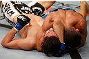 STOCKHOLM, SWEDEN - APRIL 06:  (R-L) Diego Brandao secures an arm triangle choke submission against Pablo Garza in their featherweight fight at the Ericsson Globe Arena on April 6, 2013 in Stockholm, Sweden.  (Photo by Josh Hedges/Zuffa LLC/Zuffa LLC via Getty Images)