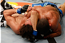 STOCKHOLM, SWEDEN - APRIL 06:  (R-L) Diego Brandao secures an arm triangle choke submission against Pablo Garza in their featherweight fight at the Ericsson Globe Arena on April 6, 2013 in Stockholm, Sweden.  (Photo by Josh Hedges/Zuffa LLC/Zuffa LLC via Getty Images)
