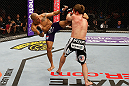STOCKHOLM, SWEDEN - APRIL 06:  (L-R) Mike Easton kicks Brad Pickett in their bantamweight fight at the Ericsson Globe Arena on April 6, 2013 in Stockholm, Sweden.  (Photo by Josh Hedges/Zuffa LLC/Zuffa LLC via Getty Images)