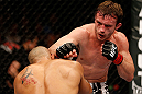 STOCKHOLM, SWEDEN - APRIL 06:  (R-L) Brad Pickett punches Mike Easton in their bantamweight fight at the Ericsson Globe Arena on April 6, 2013 in Stockholm, Sweden.  (Photo by Josh Hedges/Zuffa LLC/Zuffa LLC via Getty Images)