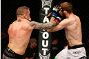 STOCKHOLM, SWEDEN - APRIL 06:  (L-R) Ross Pearson punches Ryan Couture in their lightweight fight at the Ericsson Globe Arena on April 6, 2013 in Stockholm, Sweden.  (Photo by Josh Hedges/Zuffa LLC/Zuffa LLC via Getty Images)