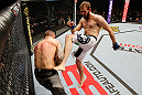 STOCKHOLM, SWEDEN - APRIL 06:  (R-L) Ryan Couture kicks Ross Pearson in their lightweight fight at the Ericsson Globe Arena on April 6, 2013 in Stockholm, Sweden.  (Photo by Josh Hedges/Zuffa LLC/Zuffa LLC via Getty Images)
