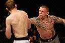 STOCKHOLM, SWEDEN - APRIL 06:  (R-L) Ross Pearson punches Ryan Couture in their lightweight fight at the Ericsson Globe Arena on April 6, 2013 in Stockholm, Sweden.  (Photo by Josh Hedges/Zuffa LLC/Zuffa LLC via Getty Images)