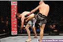 STOCKHOLM, SWEDEN - APRIL 06:  (R-L) Ross Pearson kicks Ryan Couture in their lightweight fight at the Ericsson Globe Arena on April 6, 2013 in Stockholm, Sweden.  (Photo by Josh Hedges/Zuffa LLC/Zuffa LLC via Getty Images)