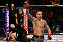 STOCKHOLM, SWEDEN - APRIL 06:  (R-L) Ross Pearson reacts after defeating Ryan Couture in their lightweight fight at the Ericsson Globe Arena on April 6, 2013 in Stockholm, Sweden.  (Photo by Josh Hedges/Zuffa LLC/Zuffa LLC via Getty Images)