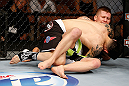 LAS VEGAS, NV - APRIL 13:   Daniel Pineda (black shorts) attempts to submit Justin Lawrence in their featherweight fight at the Mandalay Bay Events Center  on April 13, 2013 in Las Vegas, Nevada.  (Photo by Josh Hedges/Zuffa LLC/Zuffa LLC via Getty Images)  *** Local Caption *** Justin Lawrence; Daniel Pineda
