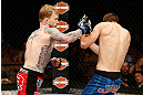 LAS VEGAS, NV - APRIL 13:   (L-R) Bart Palaszewski punches Cole Miller in their featherweight fight at the Mandalay Bay Events Center  on April 13, 2013 in Las Vegas, Nevada.  (Photo by Josh Hedges/Zuffa LLC/Zuffa LLC via Getty Images)  *** Local Caption *** Cole Miller; Bart Palaszewski