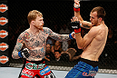 LAS VEGAS, NV - APRIL 13:   (L-R) Bart Palaszewski punches Cole Miller in their featherweight fight at the Mandalay Bay Events Center  on April 13, 2013 in Las Vegas, Nevada.  (Photo by Josh Hedges/Zuffa LLC/Zuffa LLC via Getty Images)  *** Local Caption *** Cole Miller; Bart Palaszewski