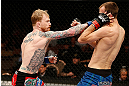 LAS VEGAS, NV - APRIL 13:   (L-R) Bart Palaszewski punches Cole Miller in their featherweight fight at the Mandalay Bay Events Center  on April 13, 2013 in Las Vegas, Nevada.  (Photo by Josh Hedges/Zuffa LLC/Zuffa LLC via Getty Images)  *** Local Caption *** Cole Miller; Bart Palaszewski